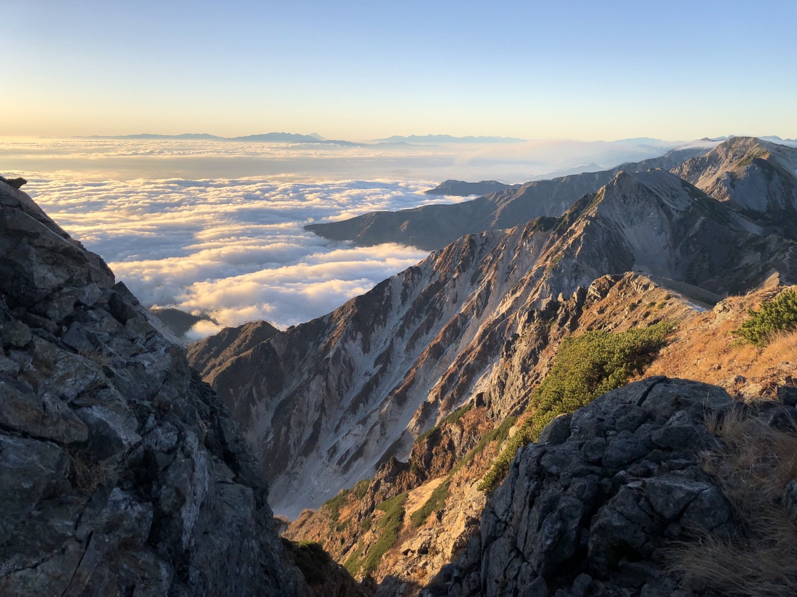 Autumn ridge trail on Mt. Shirouma above a sea of clouds after sunrise Autumn ridge trail on Mt. Shirouma above a sea of clouds after sunrise